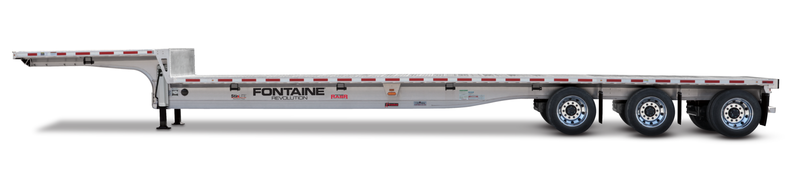 A long, silver flatbed trailer is displayed with a sleek design and multiple wheels, showcasing its brand name prominently along the side.