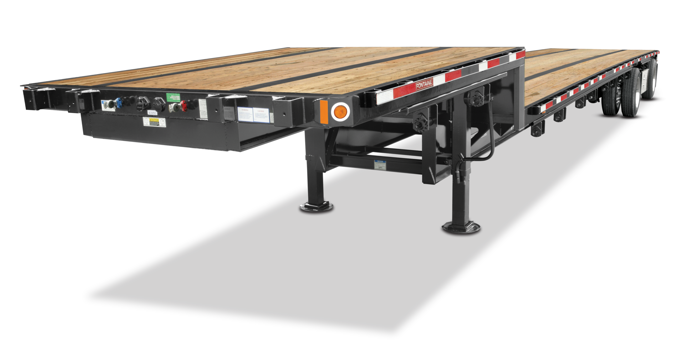 A flatbed trailer features a long, open deck with wooden planks and a sturdy metal frame, designed for transporting large cargo.