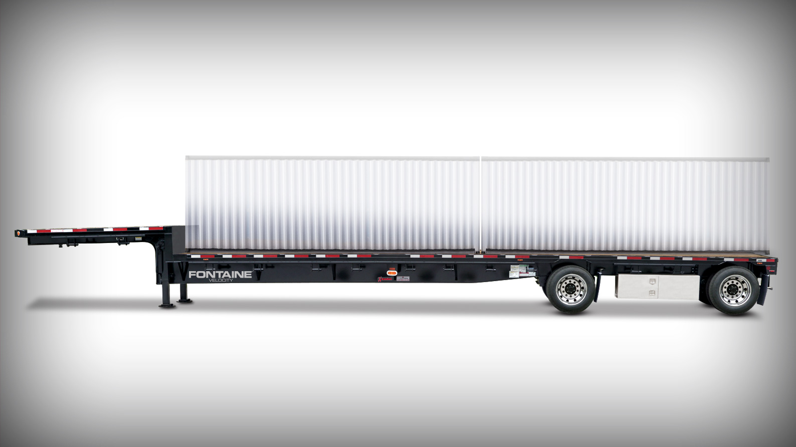 A flatbed trailer with a sleek design, featuring black and silver elements and a container placed on top.